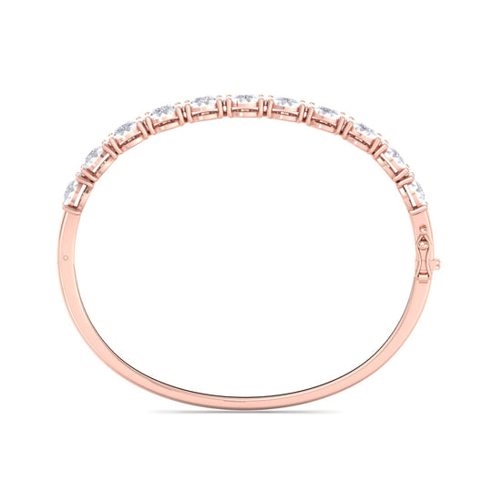 Bangle in yellow gold with white diamonds of 3.30 ct in weight with miracle plate setting