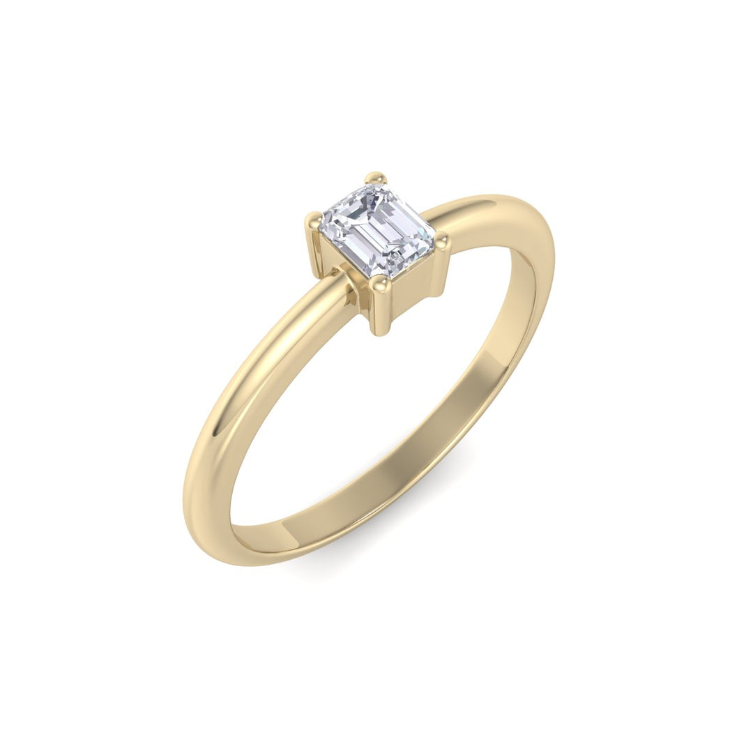 Emerald shaped petite diamond ring in yellow gold with white diamonds of 0.25 in weight
